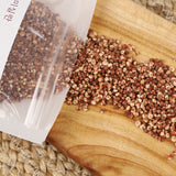 Pesticide-free Korean red millet grains spilling from a pouch