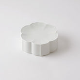 White flower-shaped flat plate with scalloped petal rim