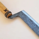 Bread knife blade and wooden handle close-up with dark bolster and rivet detail