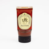 Squeezable citron grain syrup bottle with red label and cap, 11 oz net wt