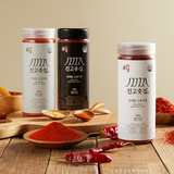 Gochugaru spice jars and powder with dried chili peppers on a wooden table