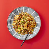 Bowl of crunchy chili crisp mixed with chopped garlic and chili, with spoon