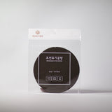 Round dark Bronzeware scrub sponge in clear plastic package