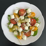 Flower 08 plate with salad of mixed greens, tomatoes, and diced vegetables