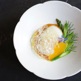 Flower 08 plate with white scalloped rim, holding a fried egg and herb garnish
