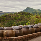 Jang cookbook page showing rows of large outdoor jars on a terrace