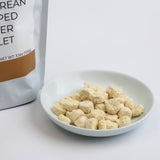Bowl of chopped ginger tablets, small beige freeze-dried pieces