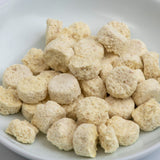 Chopped ginger tablets pile, small beige textured pieces