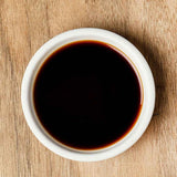Ganjang soy sauce in white bowl, dark brown liquid