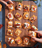 Crunchy kimchi chip bites on a wooden board with toppings