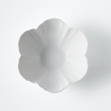 White round scalloped plate with flower petal design, wide rim