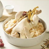 Roasted rice porridge with chicken pieces in a white bowl