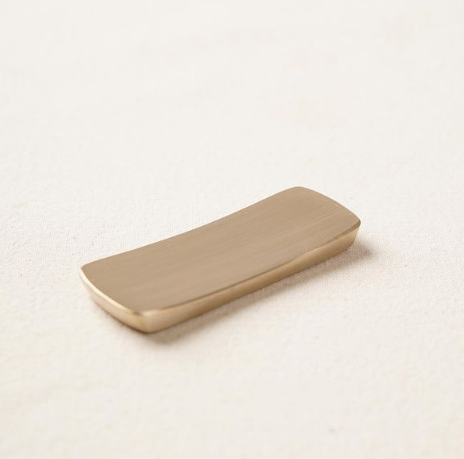 Bronzeware cutlery rest, long curved rectangle with smooth rounded edge