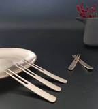 Bronzeware dessert forks set, four flat forks with textured handles and narrow tines