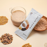 Germinated 5-colored rice powder sachet with glass cup of pale powder, plus rice grains.