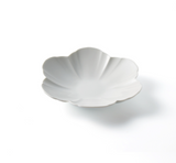 White round flower-burst plate with scalloped rim and shallow bowl shape