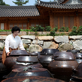 Bamboo salt pots with metal lids at a traditional courtyard stall