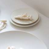 Round serving plate, white with small bone-shaped figurines