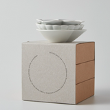 Three stacked white sauce bowls on a cube sauce set box
