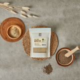 Germinated perilla seed powder pouch with two bowls of brown powder and seeds