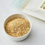 Germinated perilla seed powder in a white bowl, fine brown granules