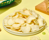 White shrimp chips in a bowl, green onion flavor, with a few chips on plate
