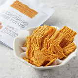 Sweet potato chips in white bowl, orange thin dried strips