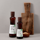 Sesame oil bottles set: two amber bottles with white labels and screw caps