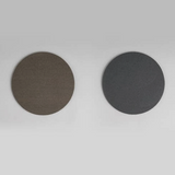Two round abrasive sponges, light brown and dark gray, side by side