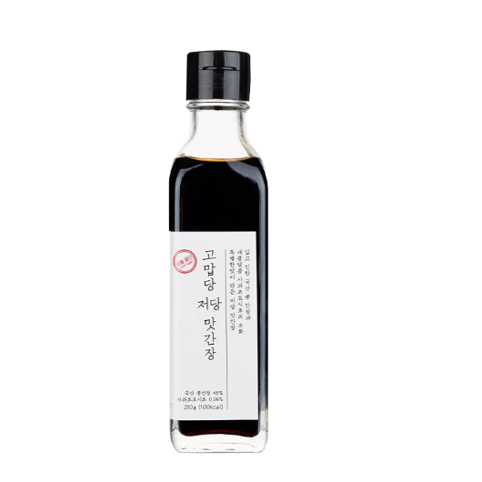Soy sauce bottle with black cap and white label filled with dark brown liquid