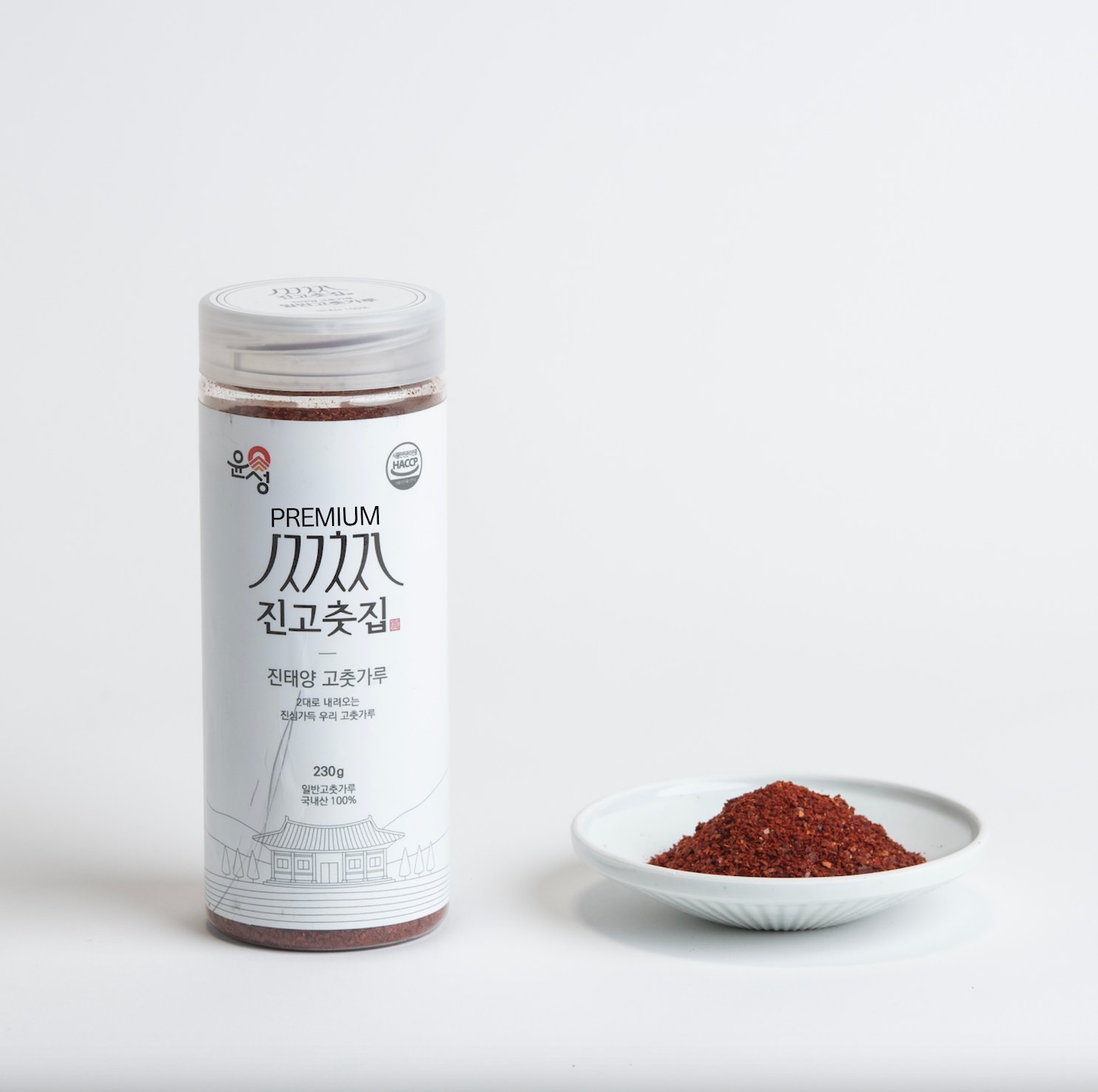 Coarse gochugaru container jar with a small bowl of red chili powder