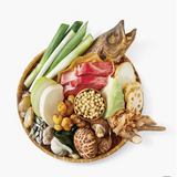 Natural seafood stock ingredients in a bowl: fish, shellfish, kelp, and vegetables.