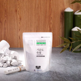 Bamboo salt pouch with printed label and white salt crystals on a cloth