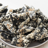 Seaweed crisps piled in a bowl with light sesame-like specks