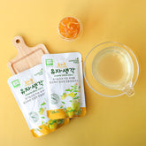 Organic yuzu-citron juice pouches with a glass of juice