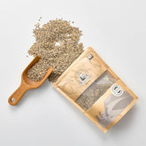 Bagged barley rice grains with wooden serving scoop