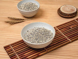 Barley rice grains in white bowl with wooden scoop