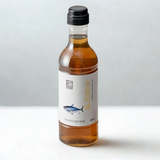 Tuna extract bottle with amber liquid and black cap