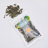 Dried sea greens in sealed pouch with dark leafy pieces on top