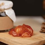 Dried kumquat jelly pieces on a wooden board