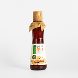 Sprouted sesame oil bottle with burlap-tied cap and front label, single bottle