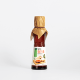 Sprouted sesame oil bottle with burlap-tied cap and front label, small size