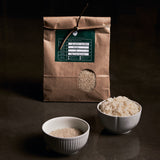 Bag of Golden Queen rice with rice grains in bowls
