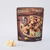 Freeze-dried minced ginger pack with tablets and ginger pieces on a white background