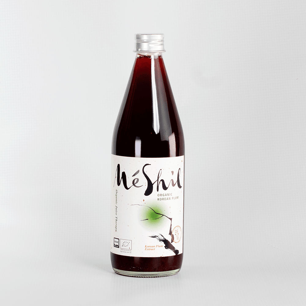 Organic Korean plum extract drink bottle with MeShil label, clear cap, dark liquid