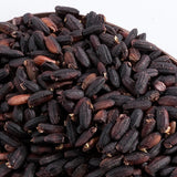 Organic germinated black rice grains close-up, dark black with brown tips