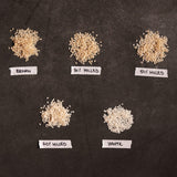 Assorted milled rice grains labeled Brown, 30%, 50%, 70%, and White
