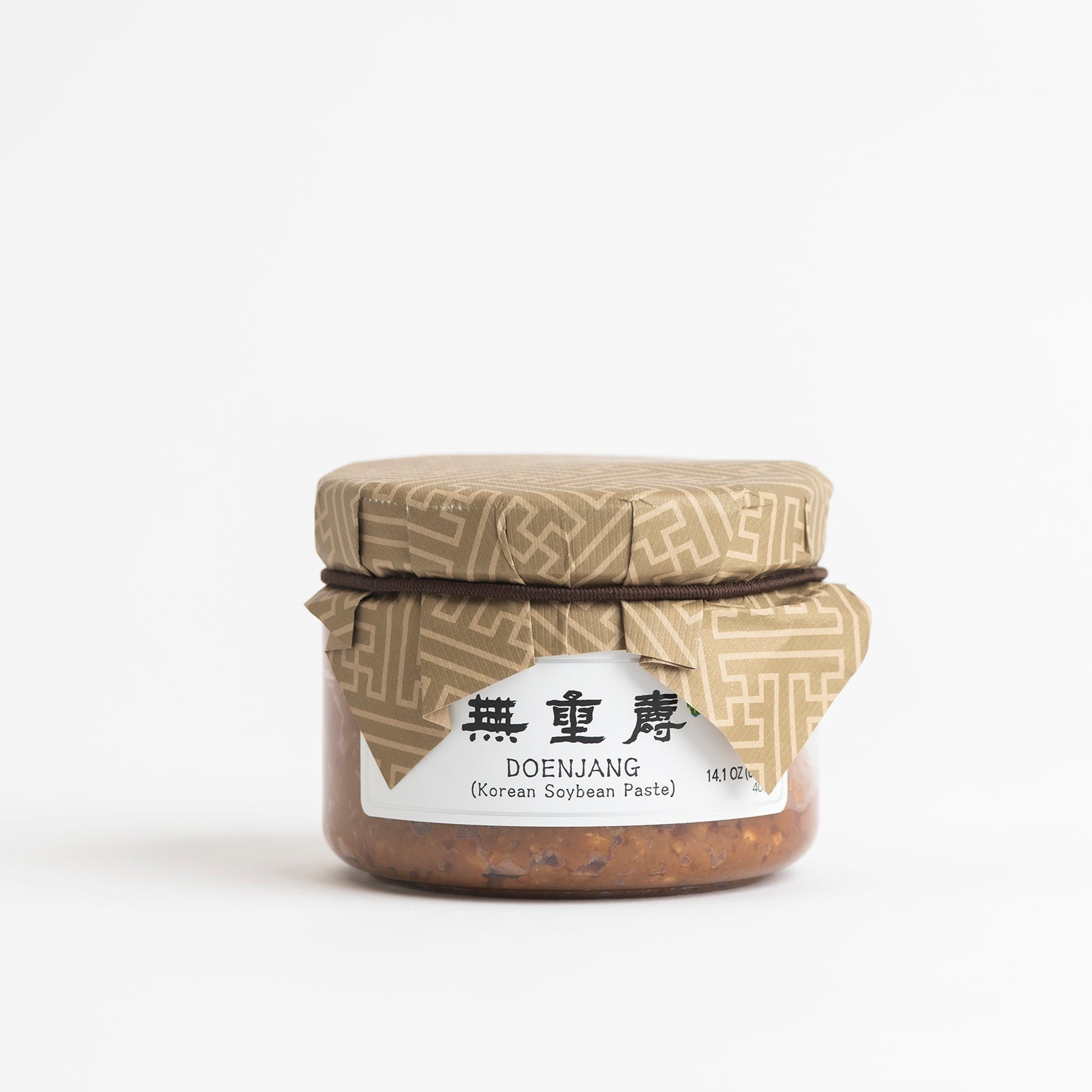 Doenjang jar of Korean soybean paste with tan lid and white label