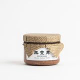 Doenjang jar of Korean soybean paste with tan lid and white label