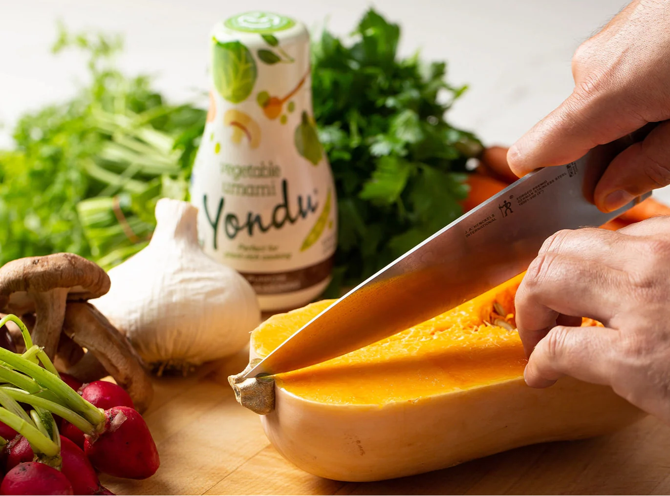 Seasoning sauce bottle with cheese on a wooden cutting board